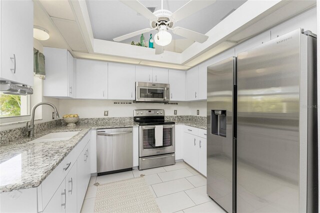 279 Mariner Ln, Rotonda West, FL 33947 - kitchen featuring appliances with stainless steel finishes, a sink, a ceiling fan, white cabinets, and light tile patterned floors