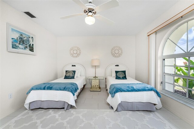 279 Mariner Ln, Rotonda West, FL 33947 - bedroom with tile patterned flooring, a ceiling fan, and baseboards