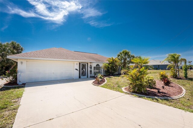 279 Mariner Ln, Rotonda West, FL 33947 - single story home with an attached garage, concrete driveway, stucco siding, and a front lawn