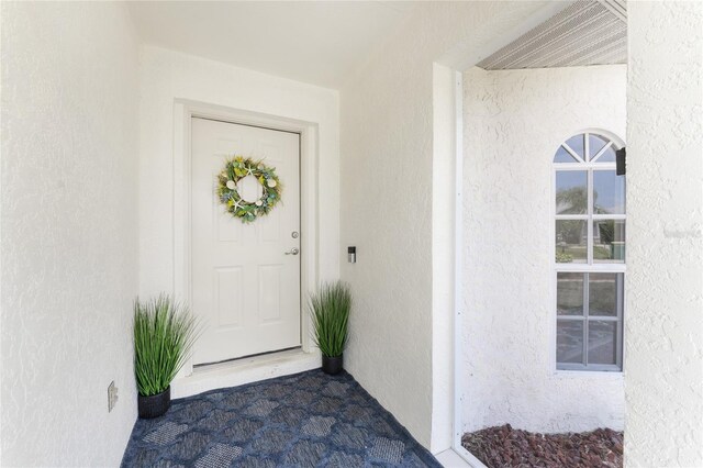 279 Mariner Ln, Rotonda West, FL 33947 - view of exterior entry featuring stucco siding