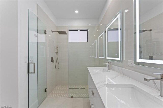 727 Colyer St E, Lehigh Acres, FL 33974 - bathroom with a shower stall, double vanity, and recessed lighting