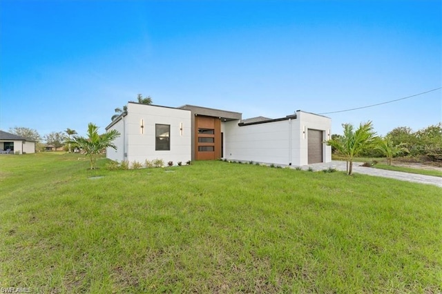 731 Colyer St E, Lehigh Acres, FL 33974 - view of front facade with driveway, an attached garage, and a front lawn