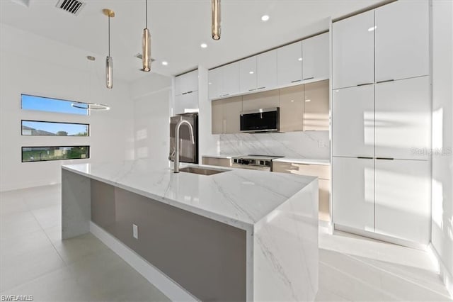 731 Colyer St E, Lehigh Acres, FL 33974 - kitchen with modern cabinets, stainless steel appliances, white cabinetry, a sink, and tasteful backsplash