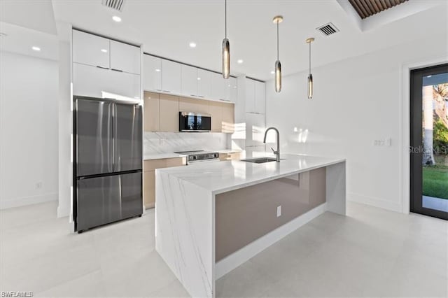 731 Colyer St E, Lehigh Acres, FL 33974 - kitchen with stainless steel appliances, a sink, modern cabinets, white cabinets, and baseboards
