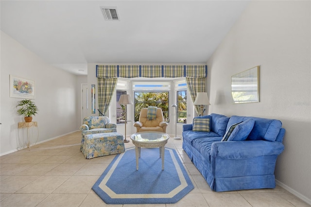 tiled living area featuring baseboards