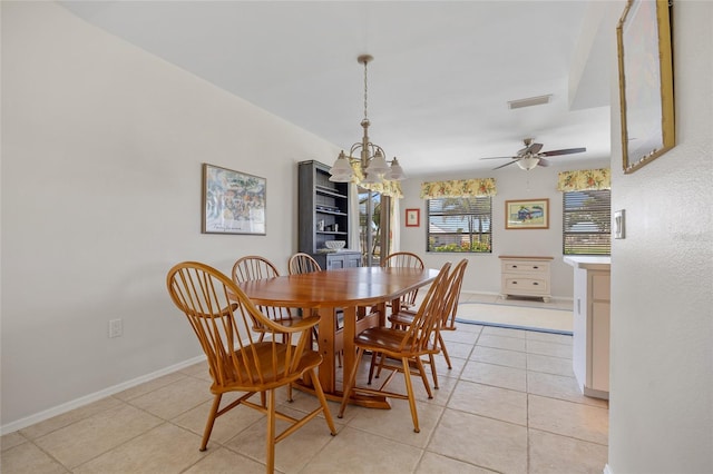 dining space featuring light tile patterned floors, ceiling fan, a chandelier, and baseboards