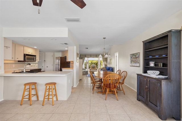 dining area with light tile patterned floors and baseboards