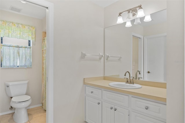 bathroom featuring toilet, tile patterned floors, vanity, and baseboards