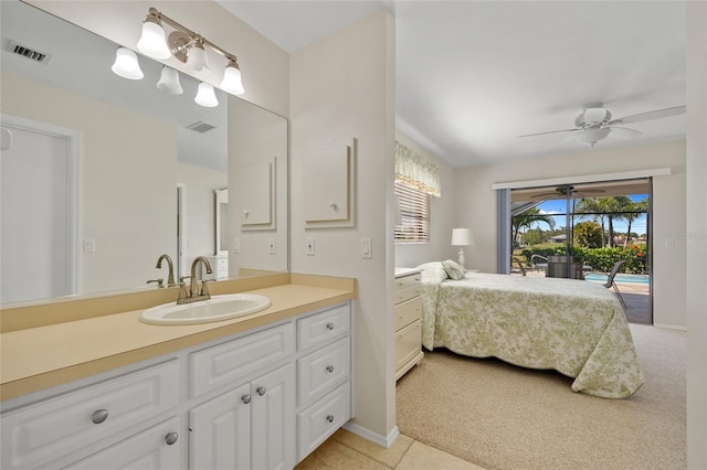 bathroom featuring ensuite bath, vanity, ceiling fan, and baseboards