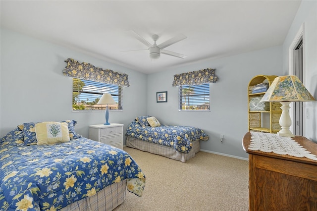 bedroom with multiple windows, carpet floors, ceiling fan, and baseboards