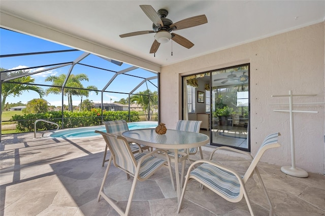 view of patio / terrace featuring a ceiling fan, an outdoor pool, glass enclosure, and outdoor dining space