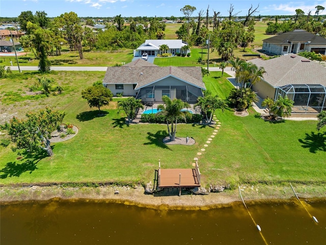 aerial perspective of suburban area featuring a pool and a nearby body of water