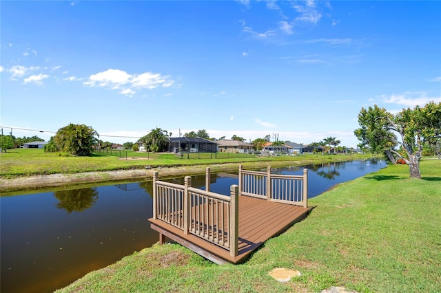 dock area featuring a lawn, a water view, and a residential view