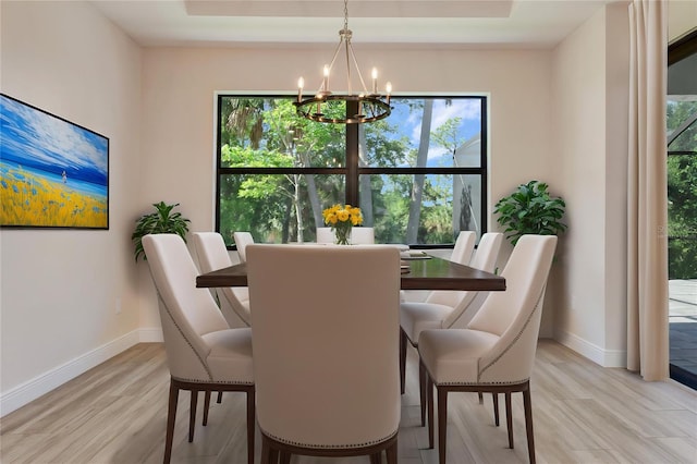 dining area with a chandelier, baseboards, and plenty of natural light