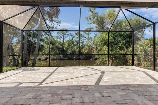 view of patio featuring glass enclosure