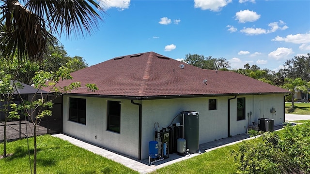 back of house with stucco siding, cooling unit, and a patio