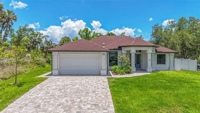 view of front of property with an attached garage, decorative driveway, and stucco siding