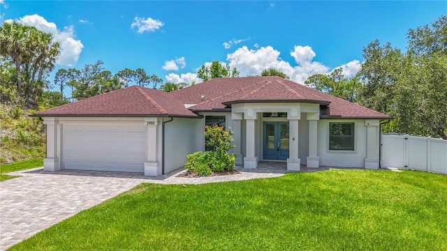 view of front of property with an attached garage, stucco siding, french doors, decorative driveway, and roof with shingles