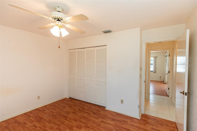 1612 Blue Lake Cir, Punta Gorda, FL 33983 - unfurnished bedroom featuring light wood finished floors, a closet, and a ceiling fan