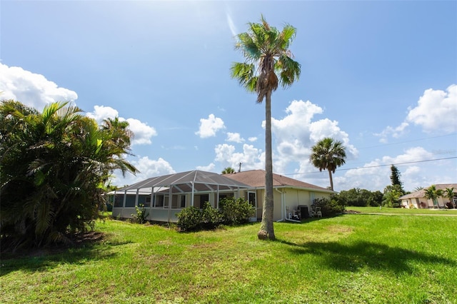 1612 Blue Lake Cir, Punta Gorda, FL 33983 - back of property with a lawn and glass enclosure