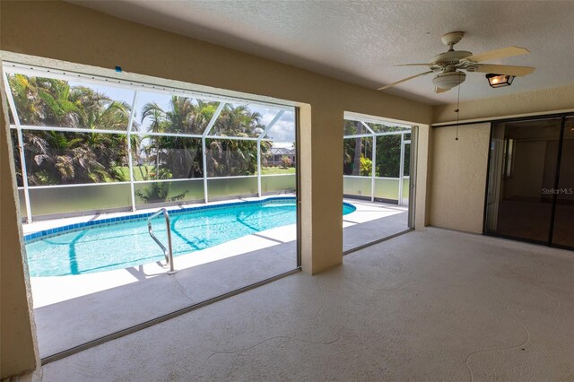 1612 Blue Lake Cir, Punta Gorda, FL 33983 - outdoor pool with ceiling fan, a patio, and glass enclosure