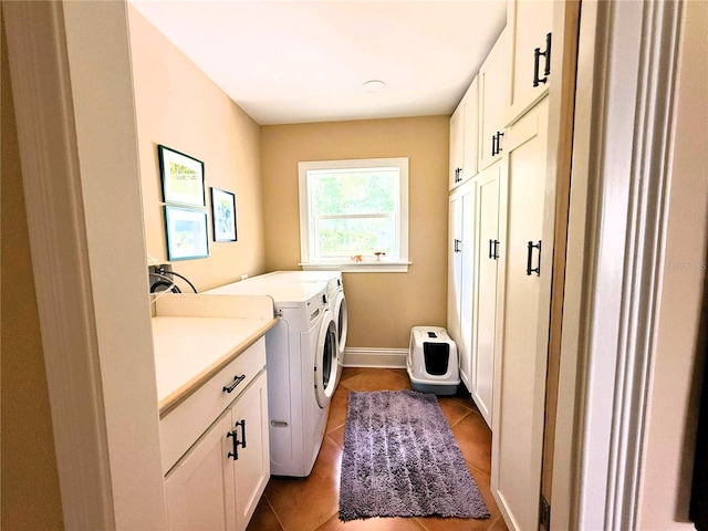 1005 S Sands Paradise Pt, Inverness, FL 34450 - clothes washing area featuring cabinet space, washing machine and clothes dryer, dark tile patterned flooring, and baseboards
