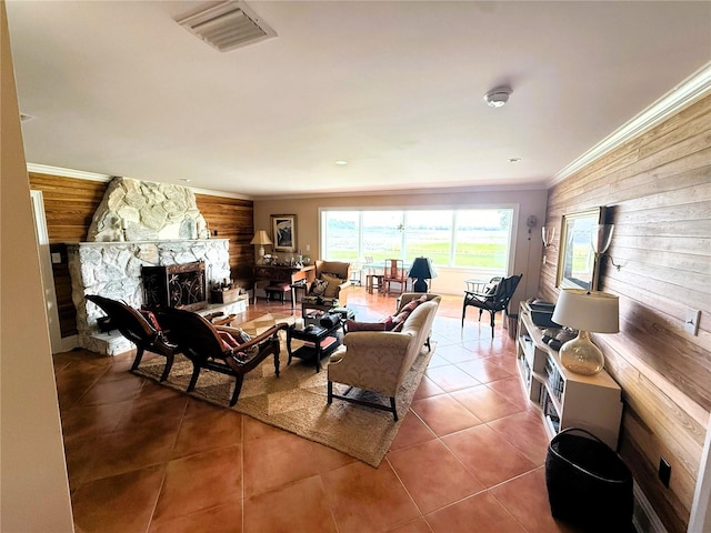 1005 S Sands Paradise Pt, Inverness, FL 34450 - living area featuring wood walls, tile patterned floors, a stone fireplace, and ornamental molding