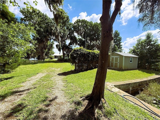 1005 S Sands Paradise Pt, Inverness, FL 34450 - view of green lawn featuring a storage unit and an outdoor structure