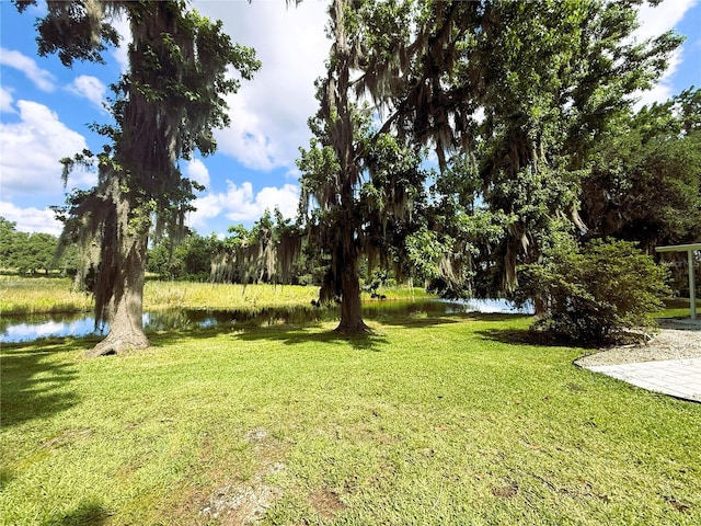 1005 S Sands Paradise Pt, Inverness, FL 34450 - view of green lawn with a water view
