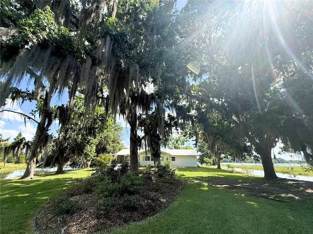 1005 S Sands Paradise Pt, Inverness, FL 34450 - view of green lawn featuring a water view