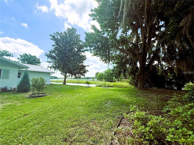1005 S Sands Paradise Pt, Inverness, FL 34450 - view of green lawn with a water view