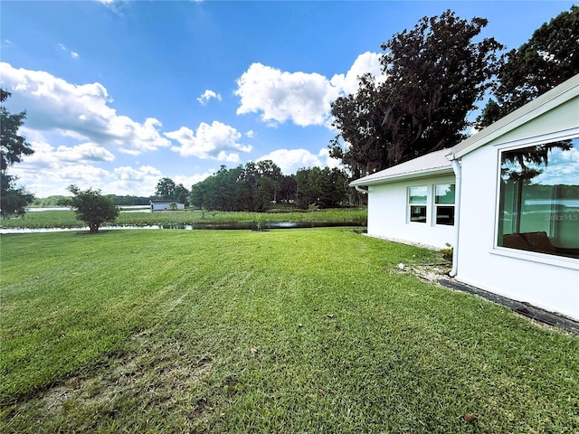 1005 S Sands Paradise Pt, Inverness, FL 34450 - view of green lawn featuring a water view