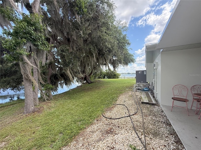 1005 S Sands Paradise Pt, Inverness, FL 34450 - view of green lawn featuring a water view and a patio area
