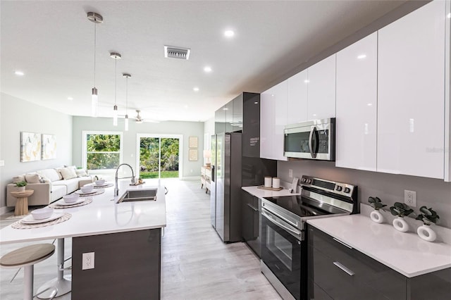 19160 Ruskin Ave, Port Charlotte, FL 33954 - kitchen with a sink, stainless steel appliances, modern cabinets, open floor plan, and light countertops