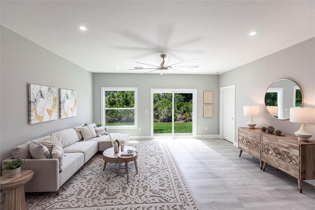 19160 Ruskin Ave, Port Charlotte, FL 33954 - living area with light wood-type flooring, ceiling fan, recessed lighting, baseboards, and a textured ceiling
