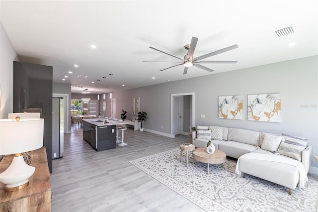19160 Ruskin Ave, Port Charlotte, FL 33954 - living area featuring ceiling fan, light wood-style floors, recessed lighting, and baseboards