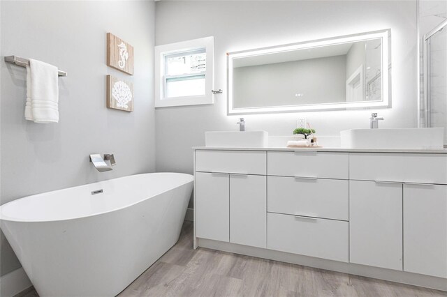 19160 Ruskin Ave, Port Charlotte, FL 33954 - full bathroom featuring double vanity, a soaking tub, wood finished floors, and an enclosed shower