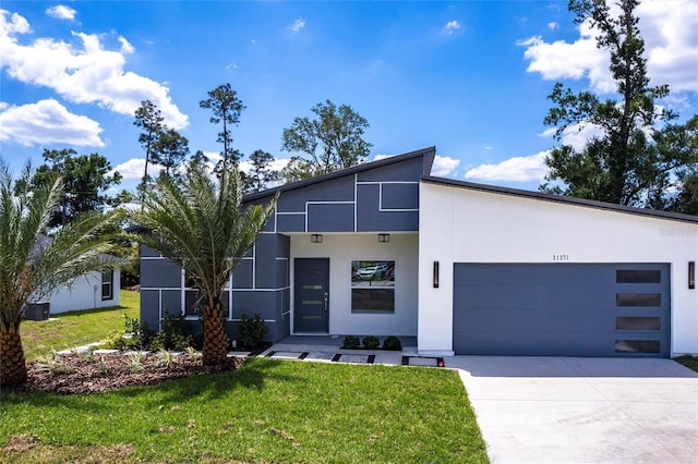 19160 Ruskin Ave, Port Charlotte, FL 33954 - contemporary home with an attached garage, stucco siding, driveway, and a front lawn