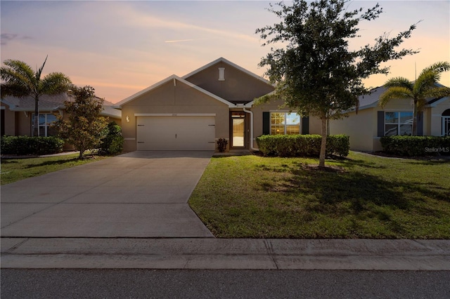 25312 E Lenox Cir, Punta Gorda, FL 33950 - view of front of property with a garage, stucco siding, a yard, and driveway