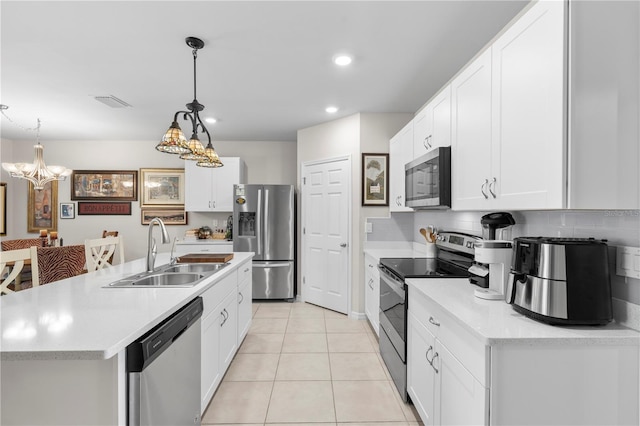 25312 E Lenox Cir, Punta Gorda, FL 33950 - kitchen with appliances with stainless steel finishes, a sink, light countertops, white cabinets, and recessed lighting