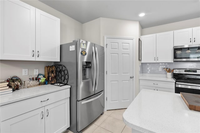 25312 E Lenox Cir, Punta Gorda, FL 33950 - kitchen featuring stainless steel appliances, white cabinetry, decorative backsplash, and light tile patterned flooring