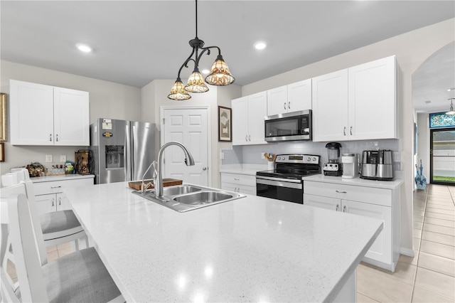 25312 E Lenox Cir, Punta Gorda, FL 33950 - kitchen featuring stainless steel appliances, a sink, a kitchen island with sink, light tile patterned floors, and recessed lighting