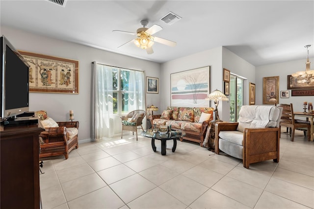 25312 E Lenox Cir, Punta Gorda, FL 33950 - living area featuring light tile patterned floors, ceiling fan, and a chandelier