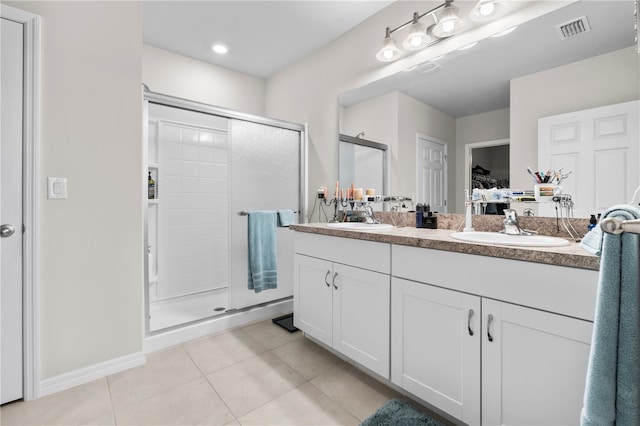 25312 E Lenox Cir, Punta Gorda, FL 33950 - full bathroom featuring a shower stall, tile patterned floors, double vanity, a walk in closet, and baseboards
