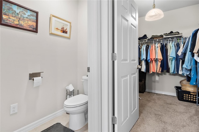 25312 E Lenox Cir, Punta Gorda, FL 33950 - bathroom featuring toilet, baseboards, and a walk in closet