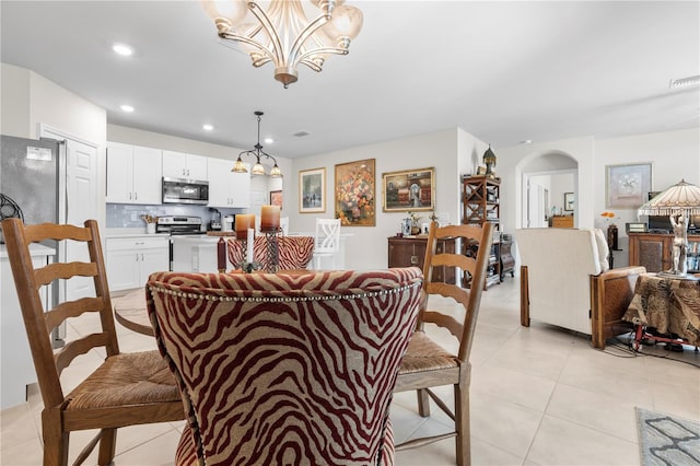 25312 E Lenox Cir, Punta Gorda, FL 33950 - dining area with a chandelier, arched walkways, light tile patterned floors, and recessed lighting