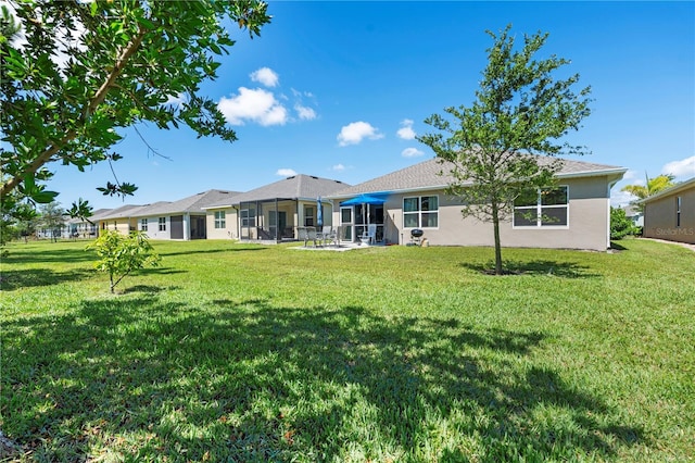 25312 E Lenox Cir, Punta Gorda, FL 33950 - back of house with a lawn and stucco siding
