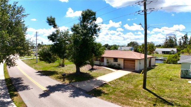 27193AND27197 Voyageur Dr, Punta Gorda, FL 33983 - view of front of home featuring driveway, a front yard, and an attached garage