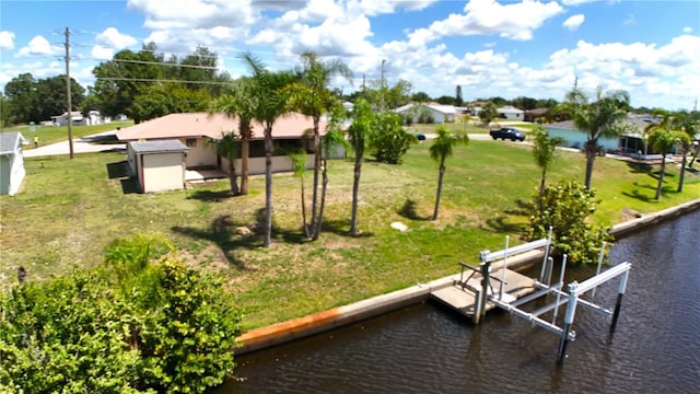27193AND27197 Voyageur Dr, Punta Gorda, FL 33983 - dock with boat lift, a water view, and a lawn