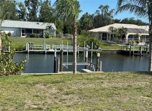 27193AND27197 Voyageur Dr, Punta Gorda, FL 33983 - dock area with boat lift, a water view, and a yard